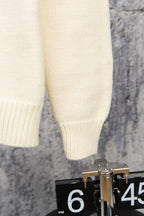 Ivory knit sweater sleeve cuff with ribbed knit detail