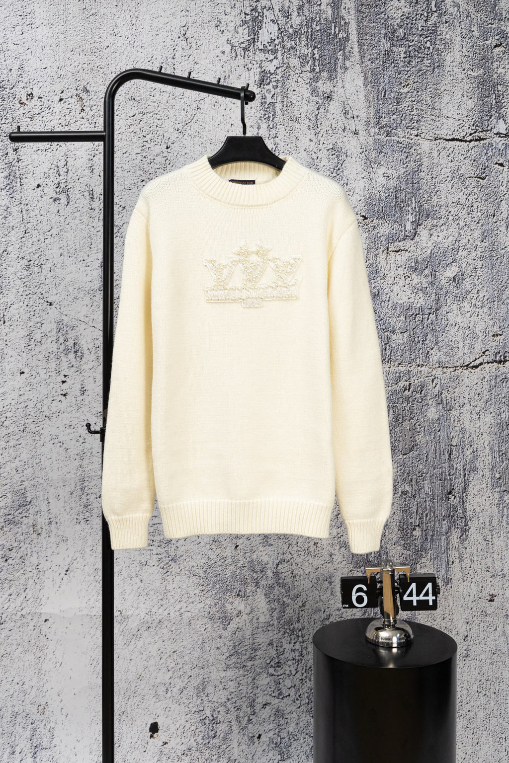 Ivory long-sleeve knit sweater with beaded crest logo