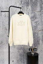 Ivory long-sleeve knit sweater with beaded crest logo