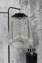 Grey long-sleeve knit sweater with zipper and small Louis Vuitton-style chest emblem