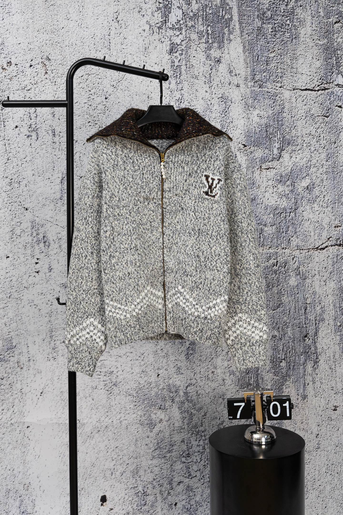 Grey long-sleeve knit sweater with zipper and small Louis Vuitton-style chest emblem