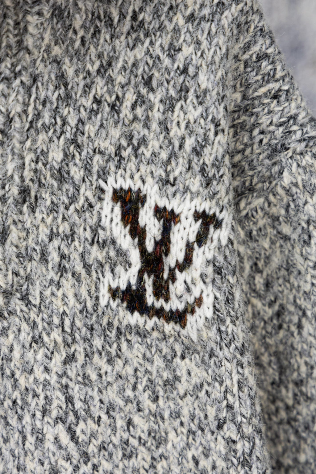 Long knit sweater with stitched smile logo patch on chest in white and brown
