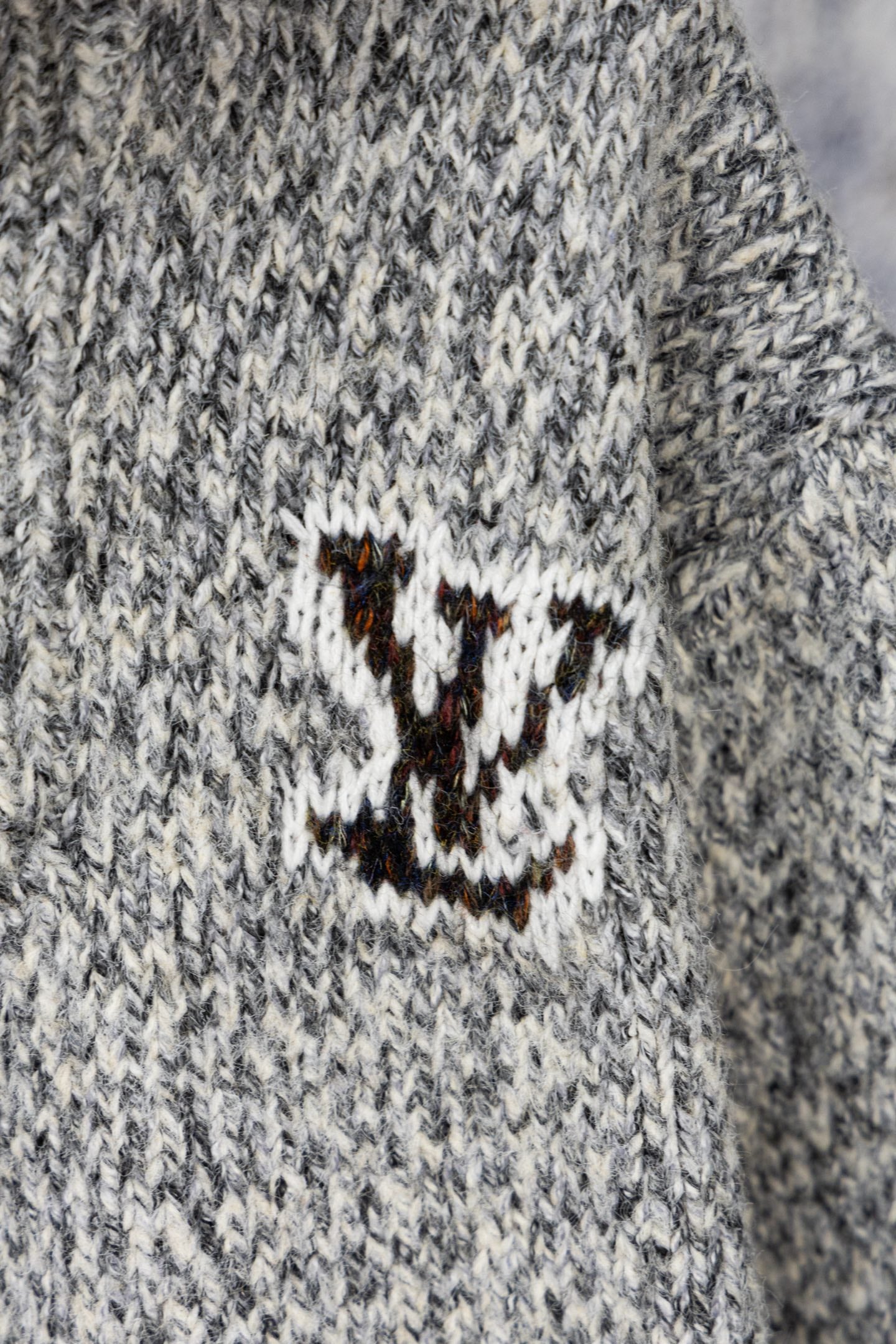 Long knit sweater with stitched smile logo patch on chest in white and brown