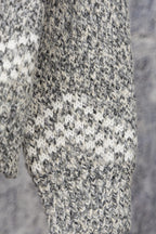 Grey speckled long-sleeve knit sweater fabric and cuff detail