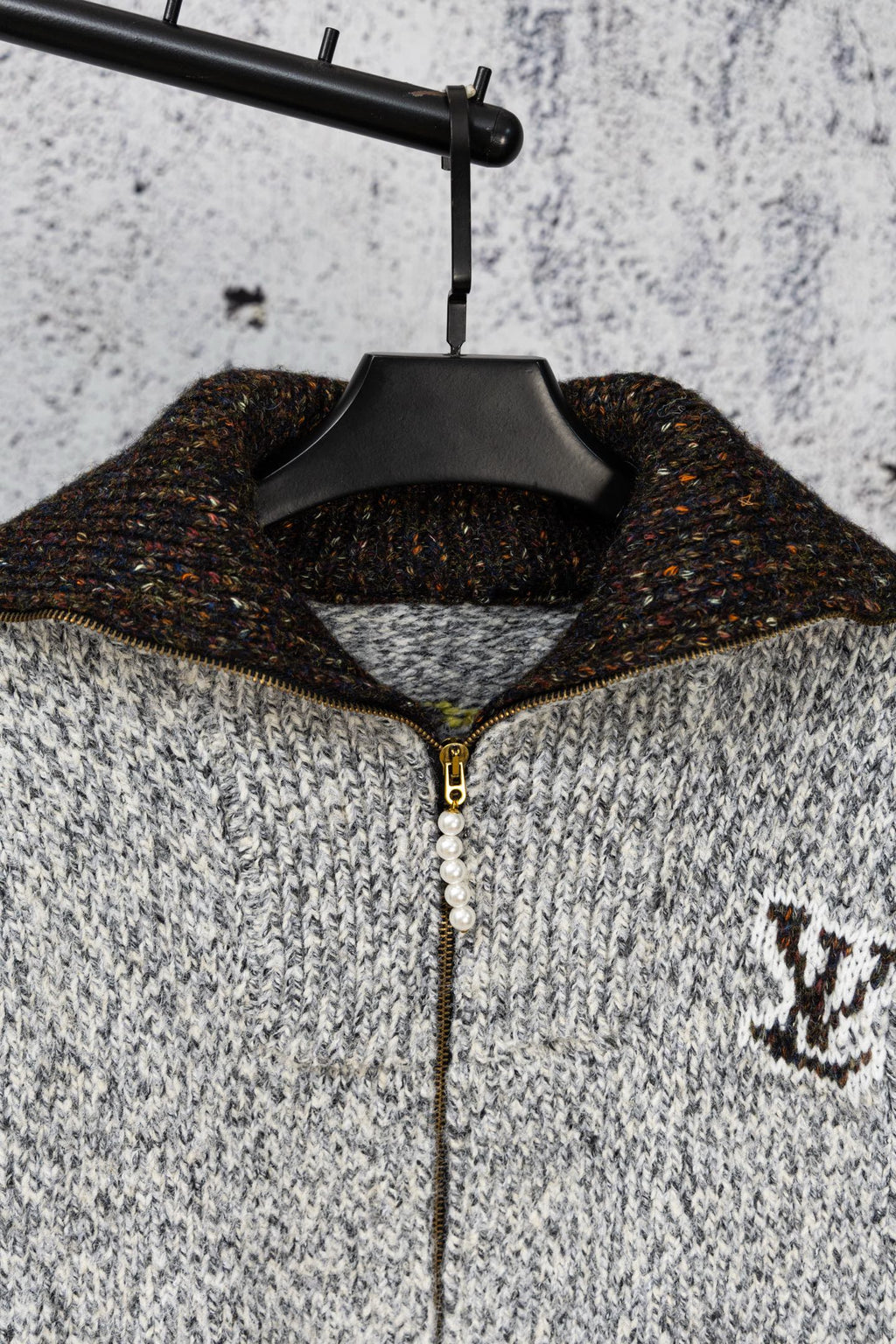 Long knit sweater on hanger, half-zip with faux pearl pull and logo patch