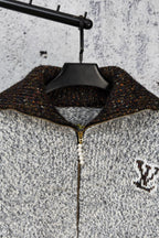 Long knit sweater on hanger, half-zip with faux pearl pull and logo patch