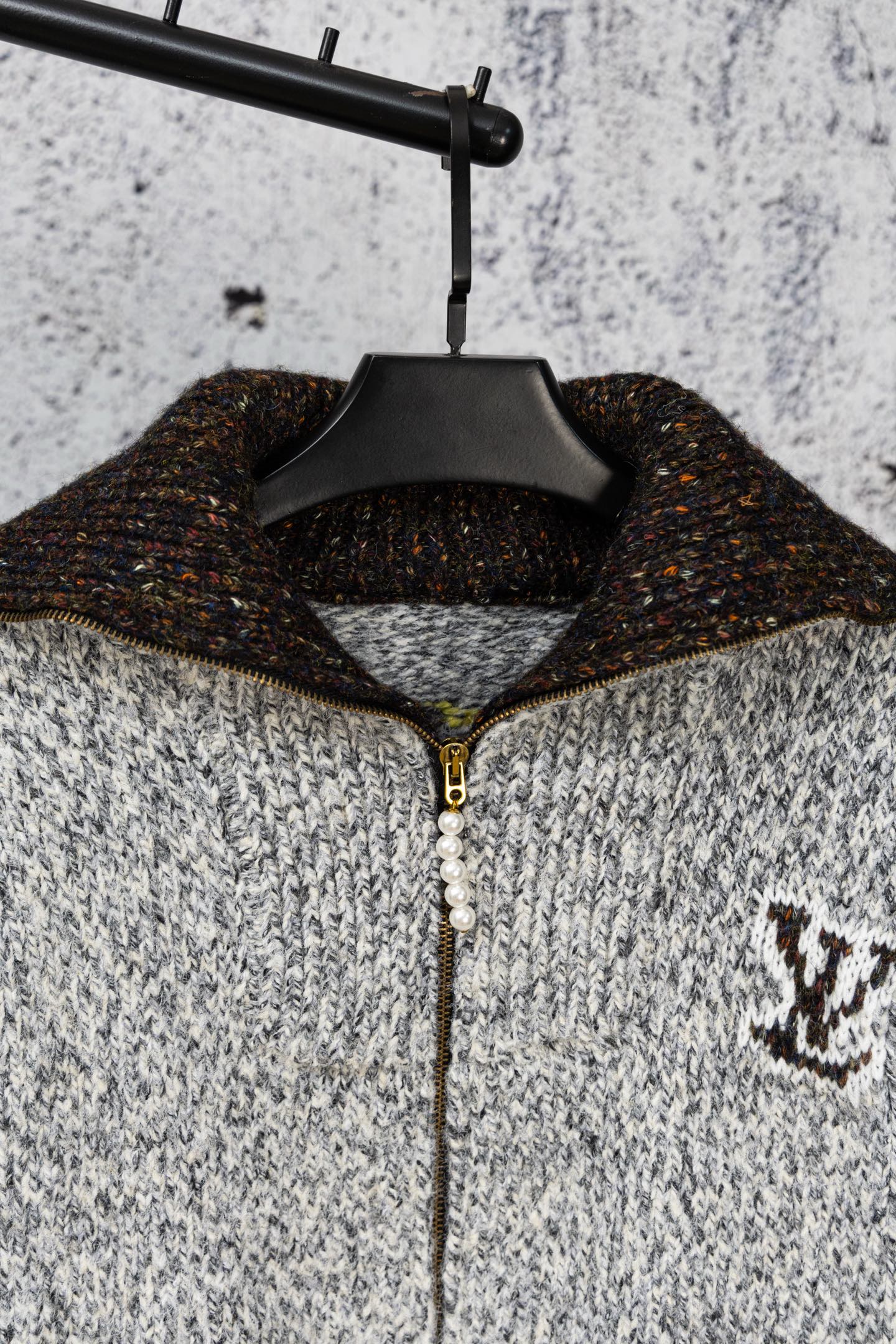 Long knit sweater on hanger, half-zip with faux pearl pull and logo patch