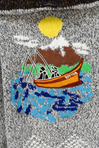 Grey knit sweater with yellow heart and colorful landscape chest graphic