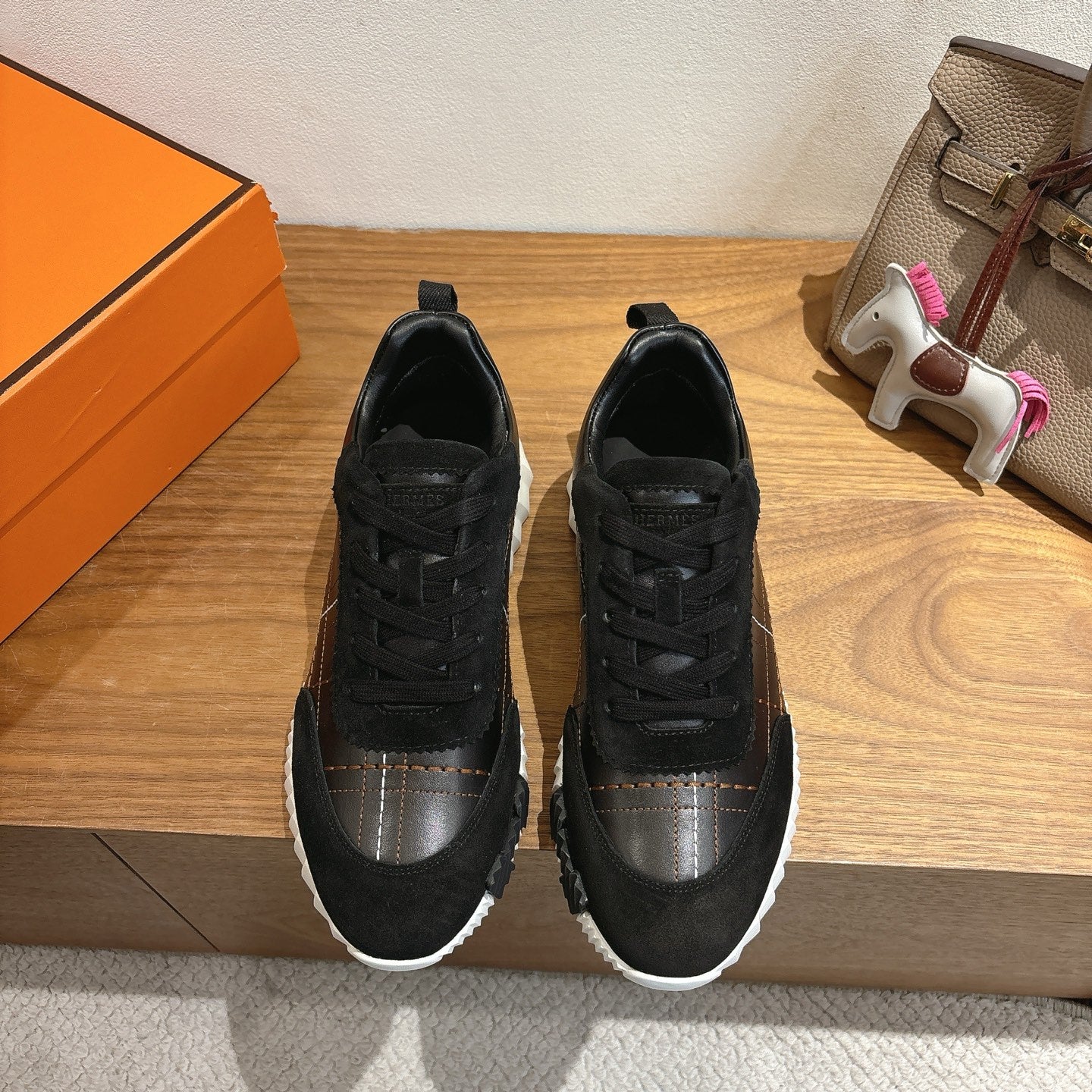 Black lace-up sneakers with silver side panel and white rubber sole