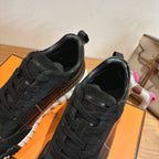 Black lace-up sneakers close-up, laces and smooth leather toe panel