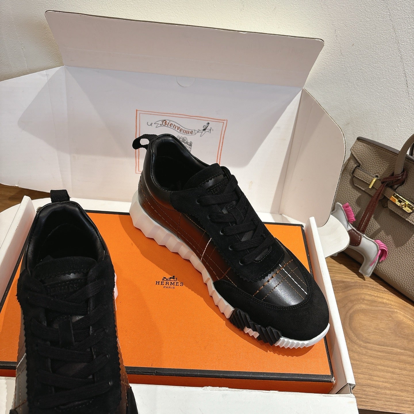 Black lace-up sneakers with silver side panel and chunky white sole