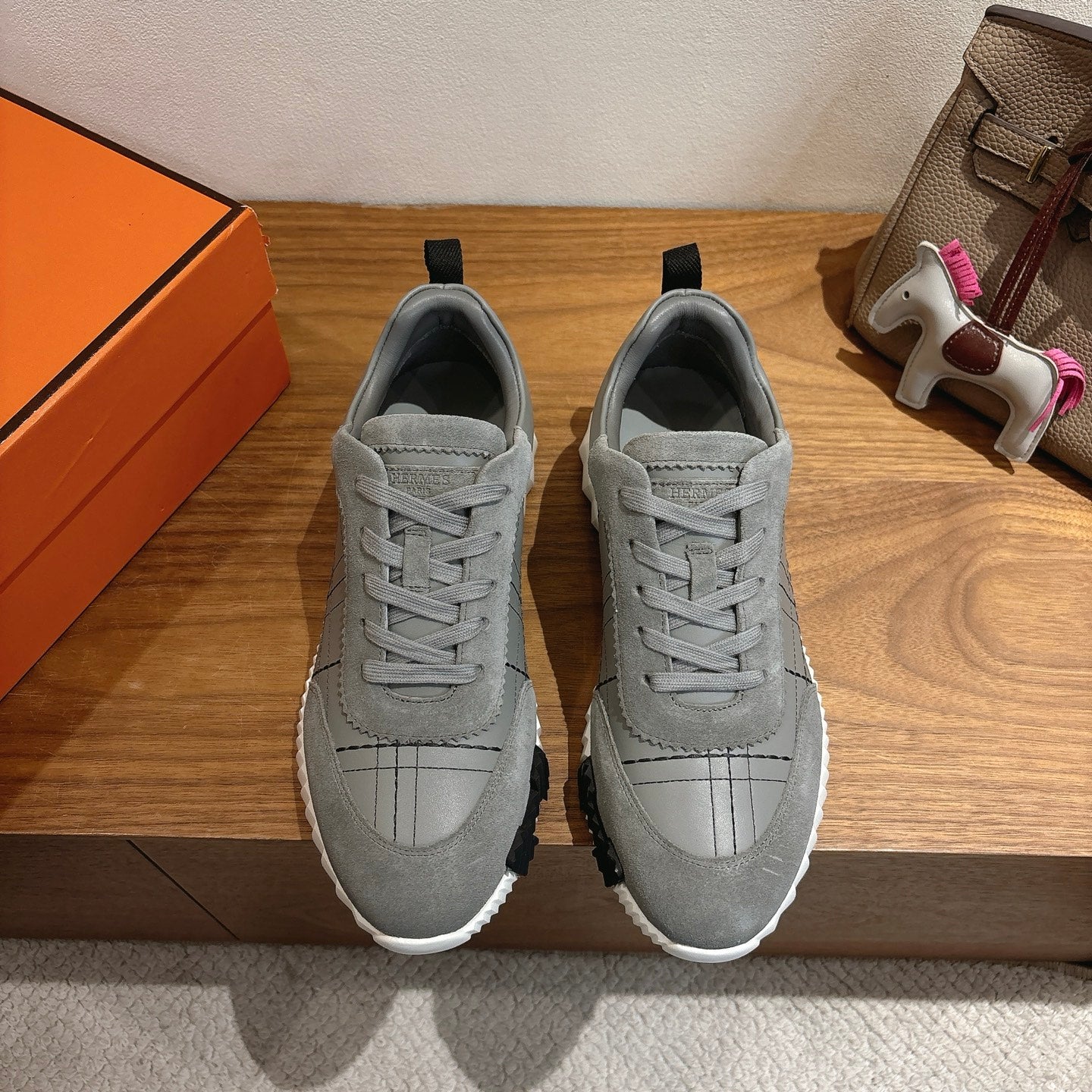 Pair of gray low-top sneakers with lace-up front and white rubber sole.