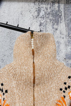 Beige knit turtleneck-style sweater with orange top and pearl-look bead necklace detail
