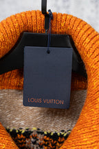 Beige knit sweater interior neckline with Louis Vuitton tag on hanger