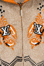 Beige knit zip-up sweater close-up with orange and black LV-style monogram patterns