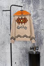 Beige knit zip-up sweater with orange hood and back orange-and-black graphic design