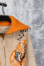 Knit cardigan with orange contrast collar and beige fabric, long sleeves, zipper front