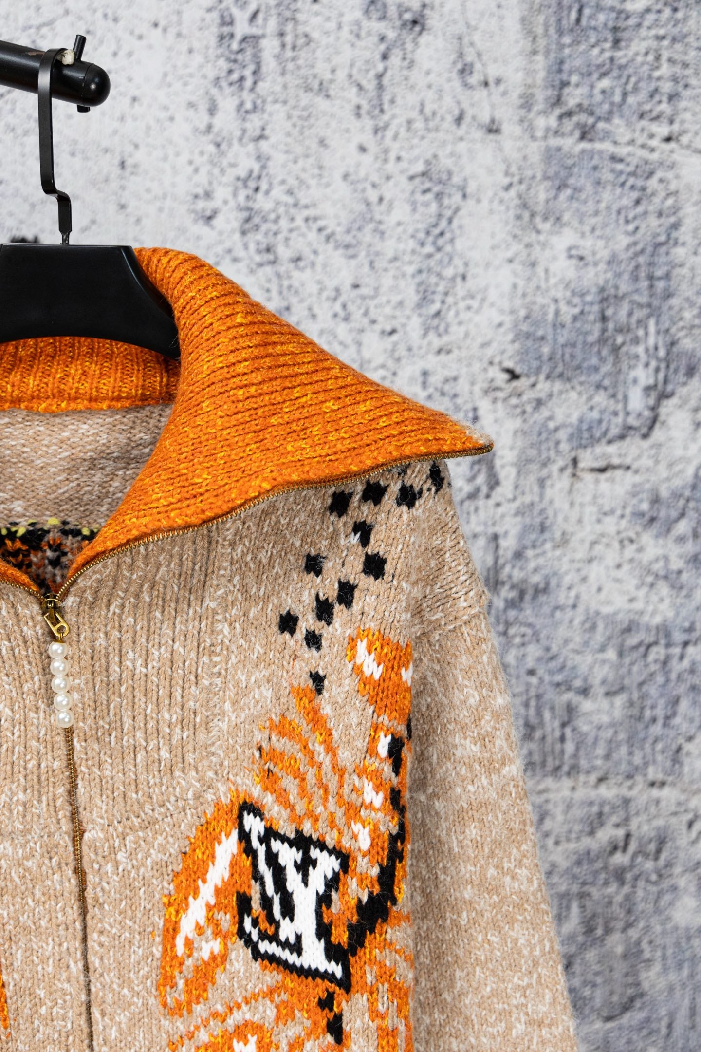 Knit cardigan with orange contrast collar and beige fabric, long sleeves, zipper front