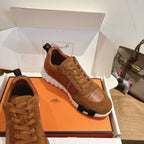 Brown lace-up sneakers with suede upper, paneled stitching, and white outsole