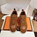 Hermes unisex sneakers, brown suede with lace-up front and white rubber sole.