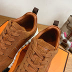 Hermes unisex sneakers close-up, brown suede lace-up with tan collar and white sole.