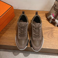 Gray low-top sneakers with lace-up closure and cushioned sole