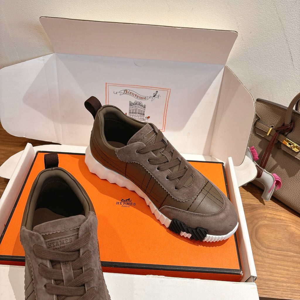 Gray lace-up sneakers in box, with side stitching and thick textured sole