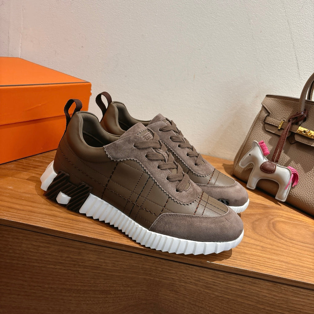 Pair of gray lace-up low-top sneakers with textured midsole