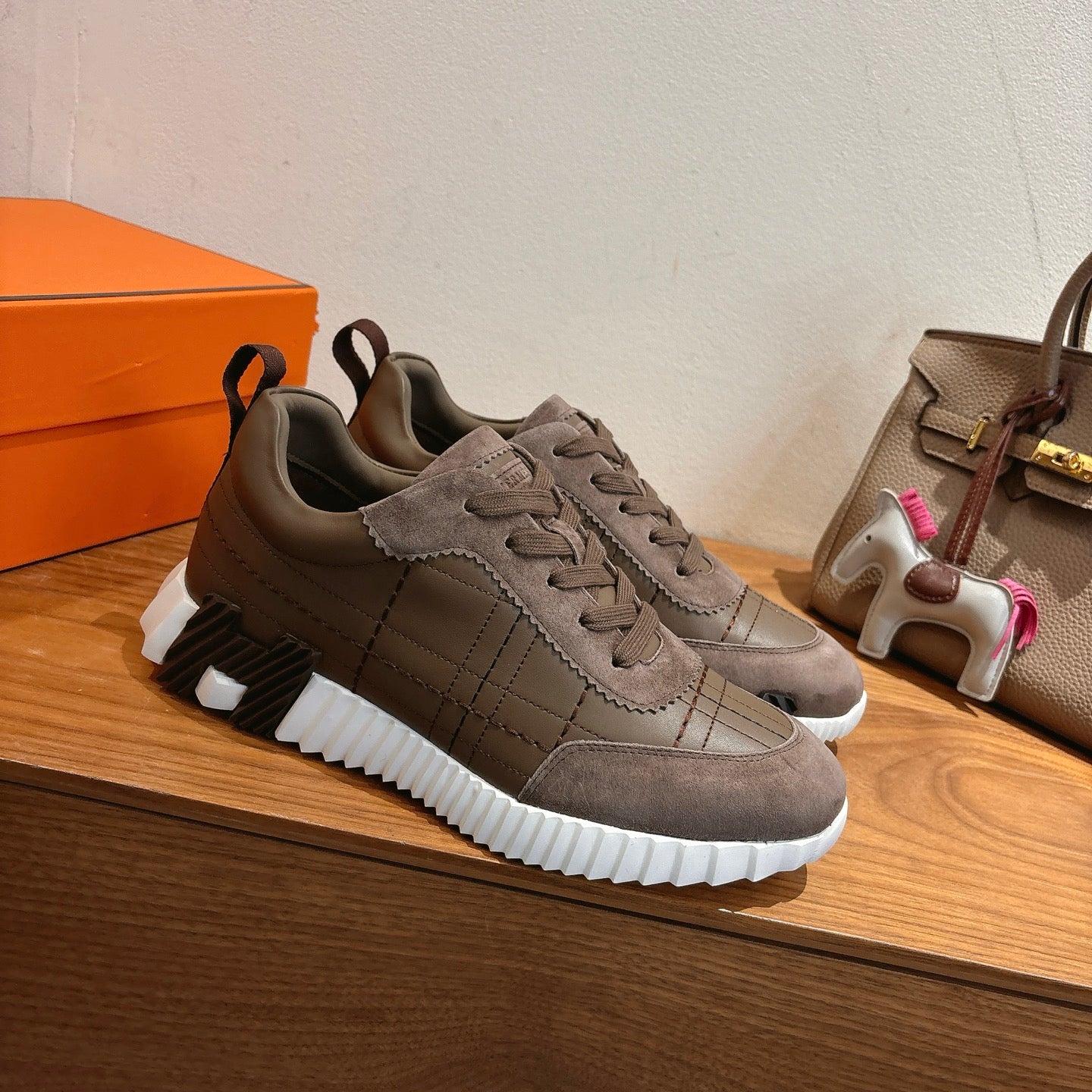 Pair of gray lace-up low-top sneakers with textured midsole