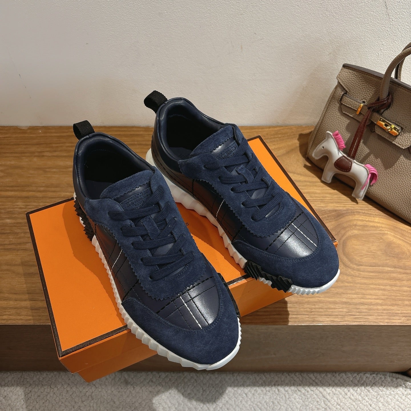 Unisex navy lace-up sneakers pair with suede uppers, silver toe panels, white soles