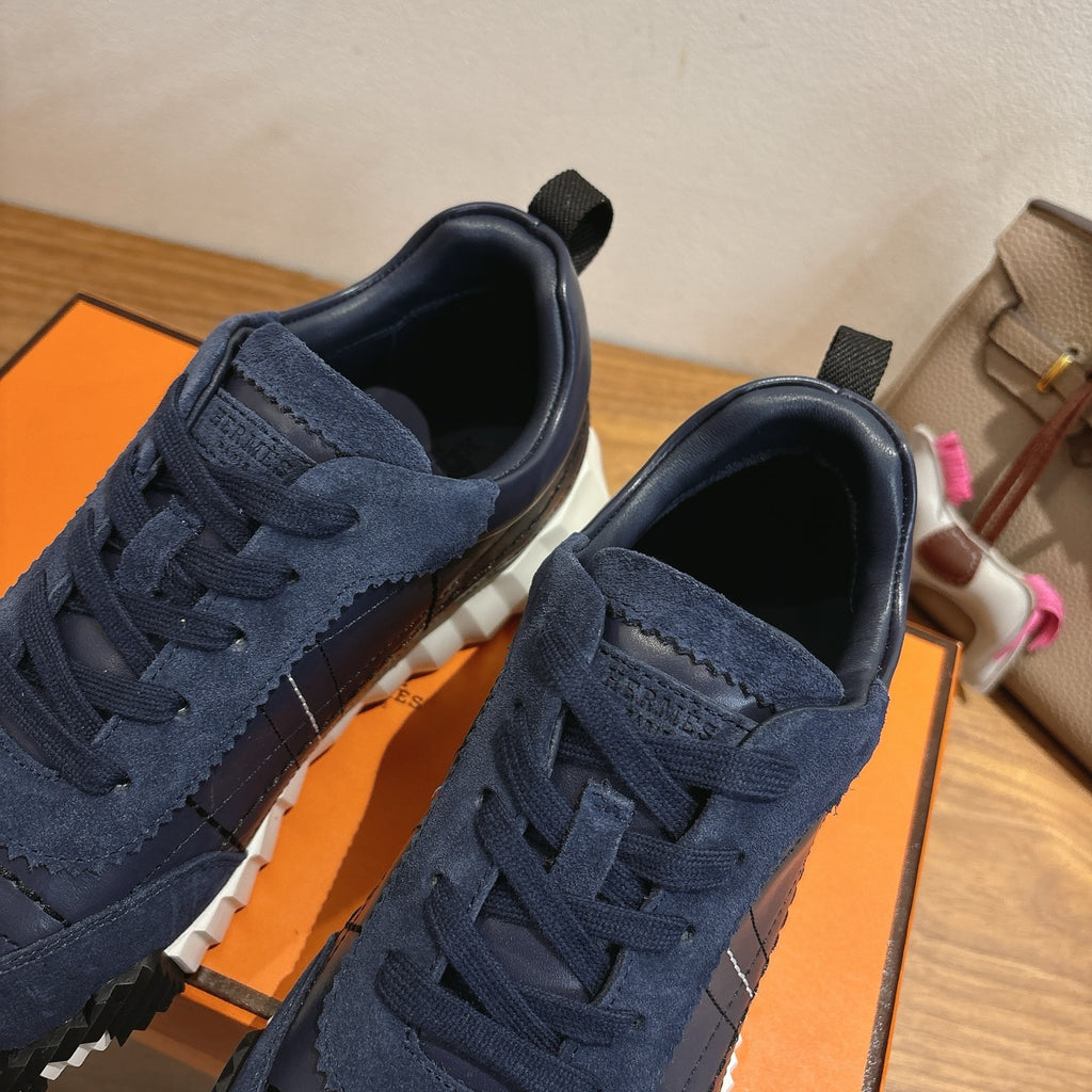 Unisex navy lace-up sneakers close-up with suede texture and silver toe panel