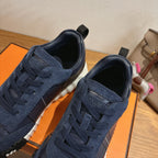 Unisex navy lace-up sneakers close-up with suede texture and silver toe panel