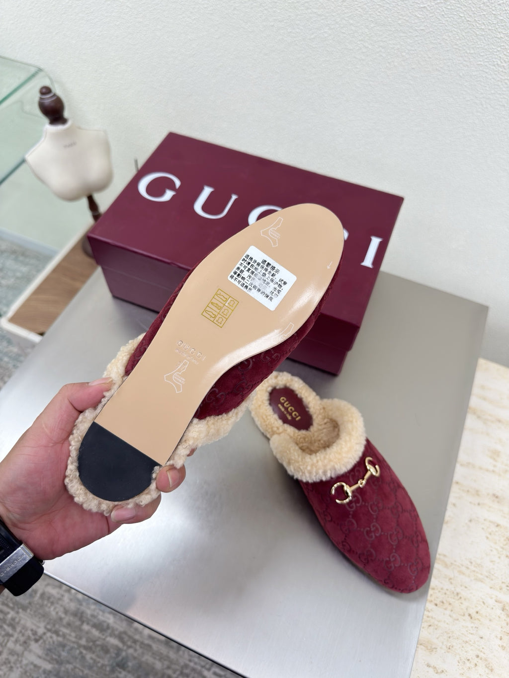 Gucci women's burgundy slip-on shoes with beige shearling interior; outsole view