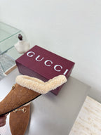 Brown suede slide mule with beige shearling strap and gold-tone horsebit detail