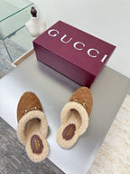 Brown suede shearling mules with gold-tone horsebit and Gucci logo footbed