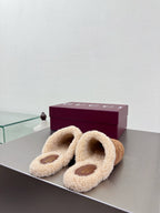Pair of brown suede mules with beige shearling lining and gold-tone horsebit