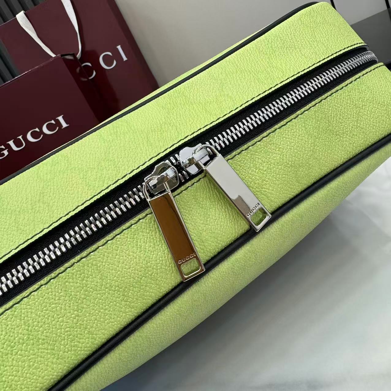 Gucci crossbody bag zipper detail with silver pull on lime green leather.