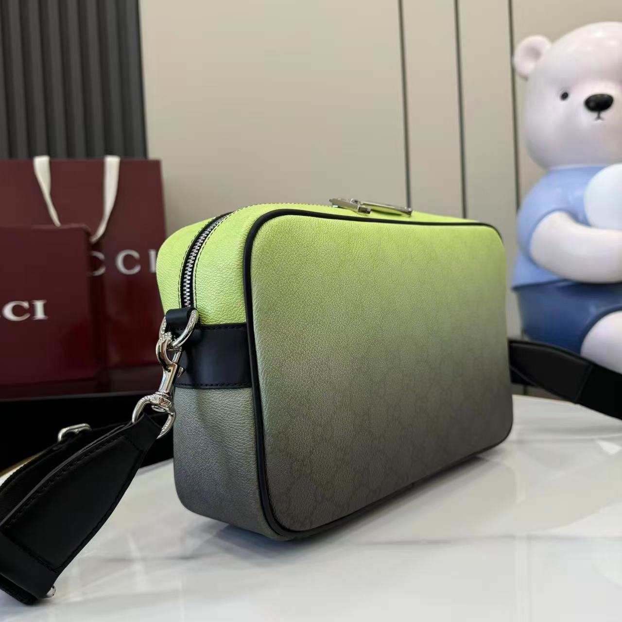 Gucci crossbody bag, lime green front with black side trim and chain strap.