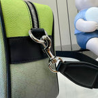 Gucci crossbody bag detail: silver-tone ring clasp, black strap, lime green panels.
