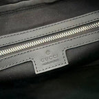 Gucci interior label on dark lining with stitching and zip pocket detail.