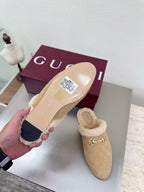 Beige mule clog showing sole and upper with tan shearling lining and gold horsebit detail