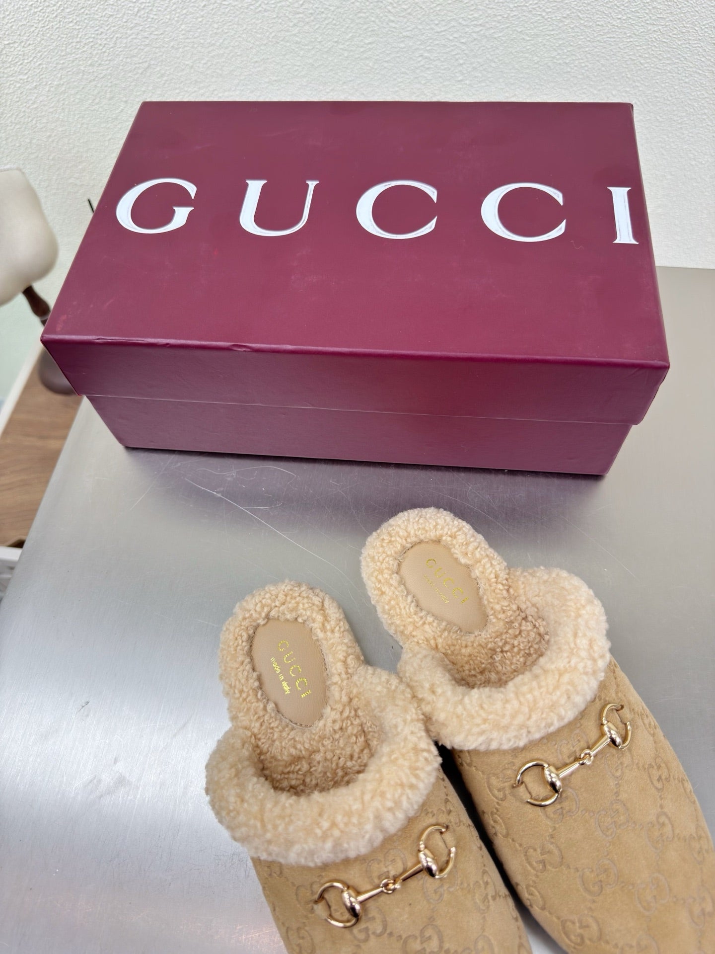 Beige GG monogram mule clogs with tan shearling lining and gold horsebit hardware