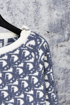 Close-up of Dior monogram knit sweater sleeve with ribbed cuff trim