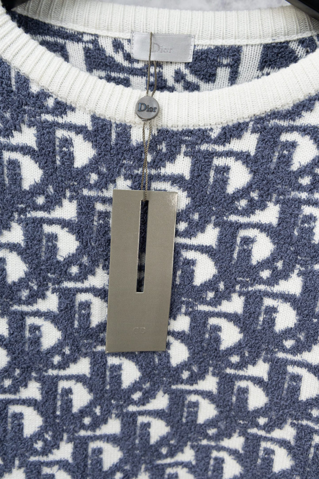 Neck label area on Dior monogram knit sweater with ribbed cream-white collar