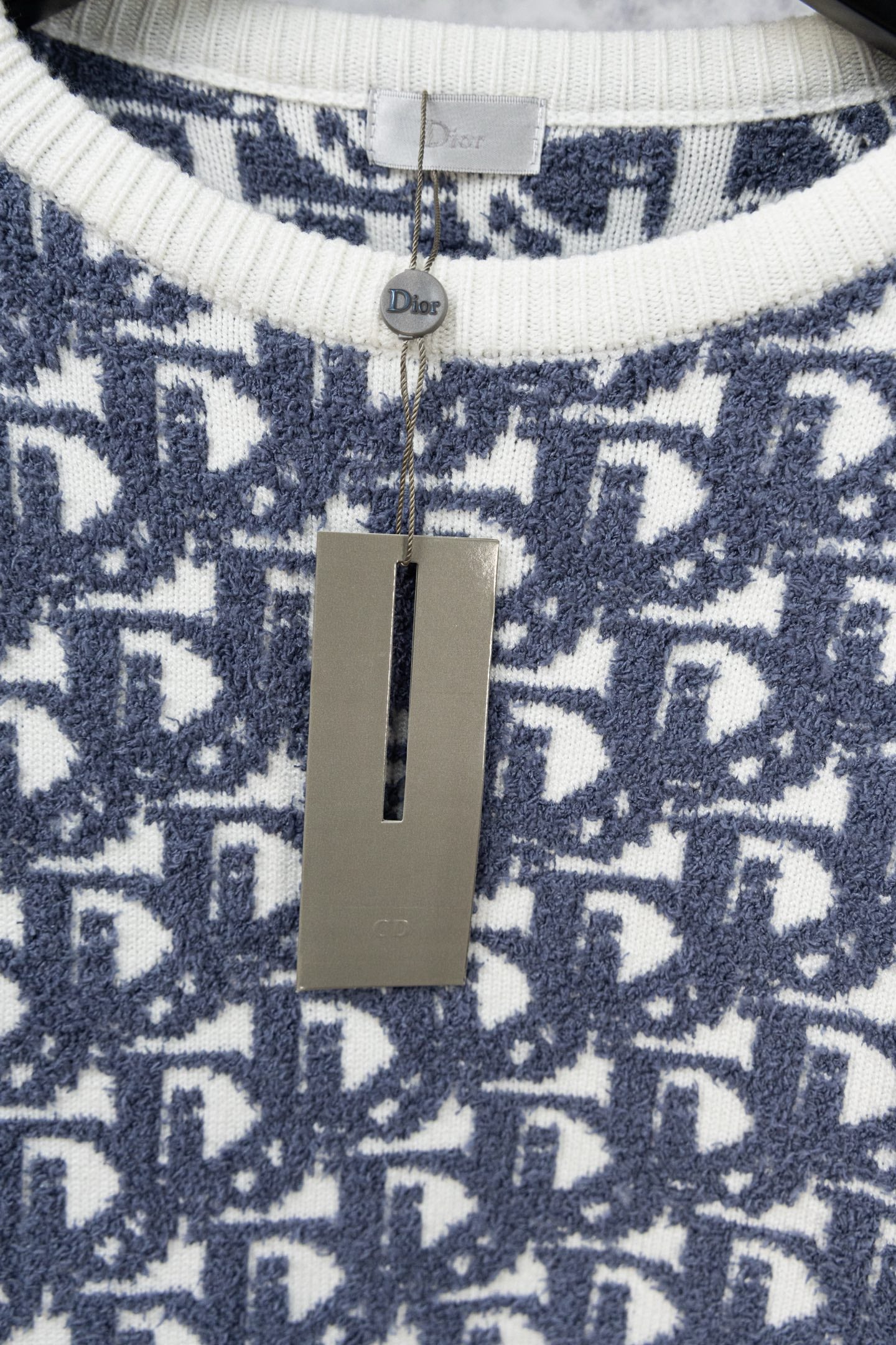 Neck label area on Dior monogram knit sweater with ribbed cream-white collar