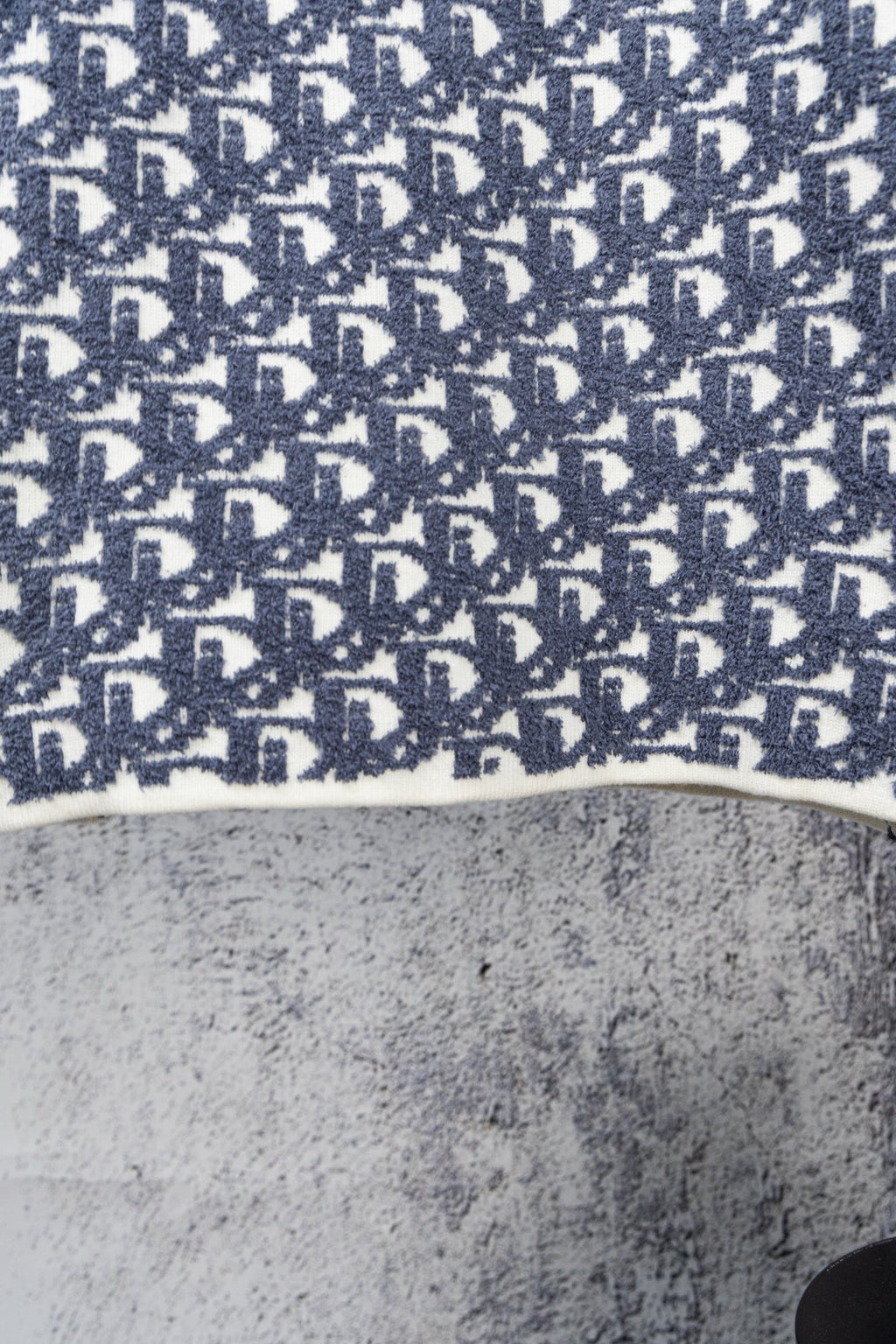Blue knit sweater hem with Dior monogram pattern and ribbed white edge
