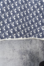 Blue knit sweater hem with Dior monogram pattern and ribbed white edge