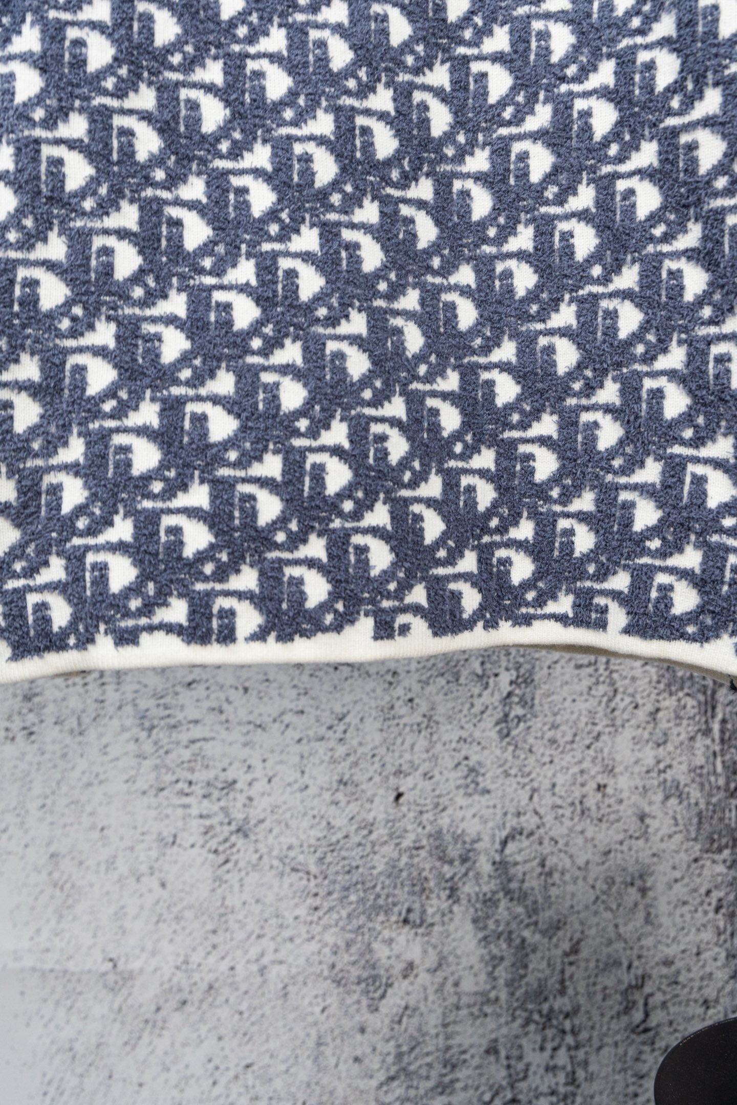 Blue knit sweater hem with Dior monogram pattern and ribbed white edge