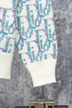 Knit cardigan sleeve and hem with blue-and-white geometric pattern