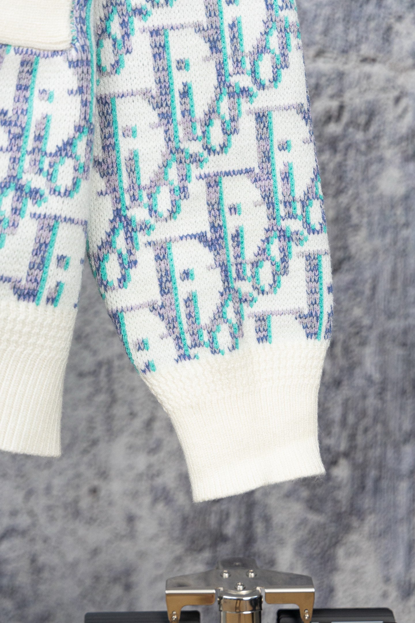 Knit cardigan sleeve and hem with blue-and-white geometric pattern